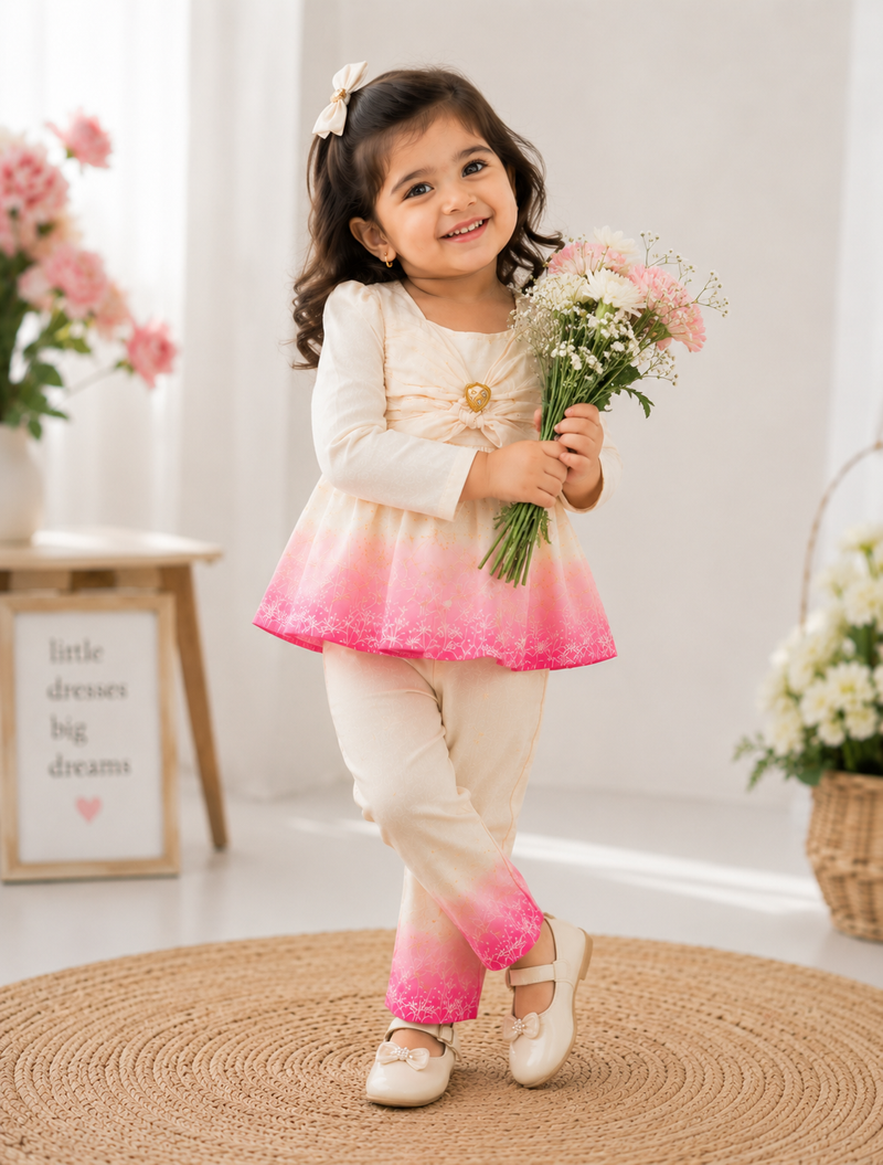Girl wearing white and pink floral printed co-ord set with full sleeve top and matching pants by Kidaura
