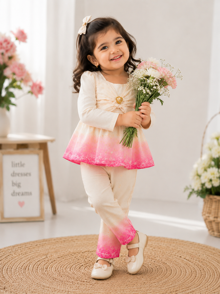 Girl wearing white and pink floral printed co-ord set with full sleeve top and matching pants by Kidaura